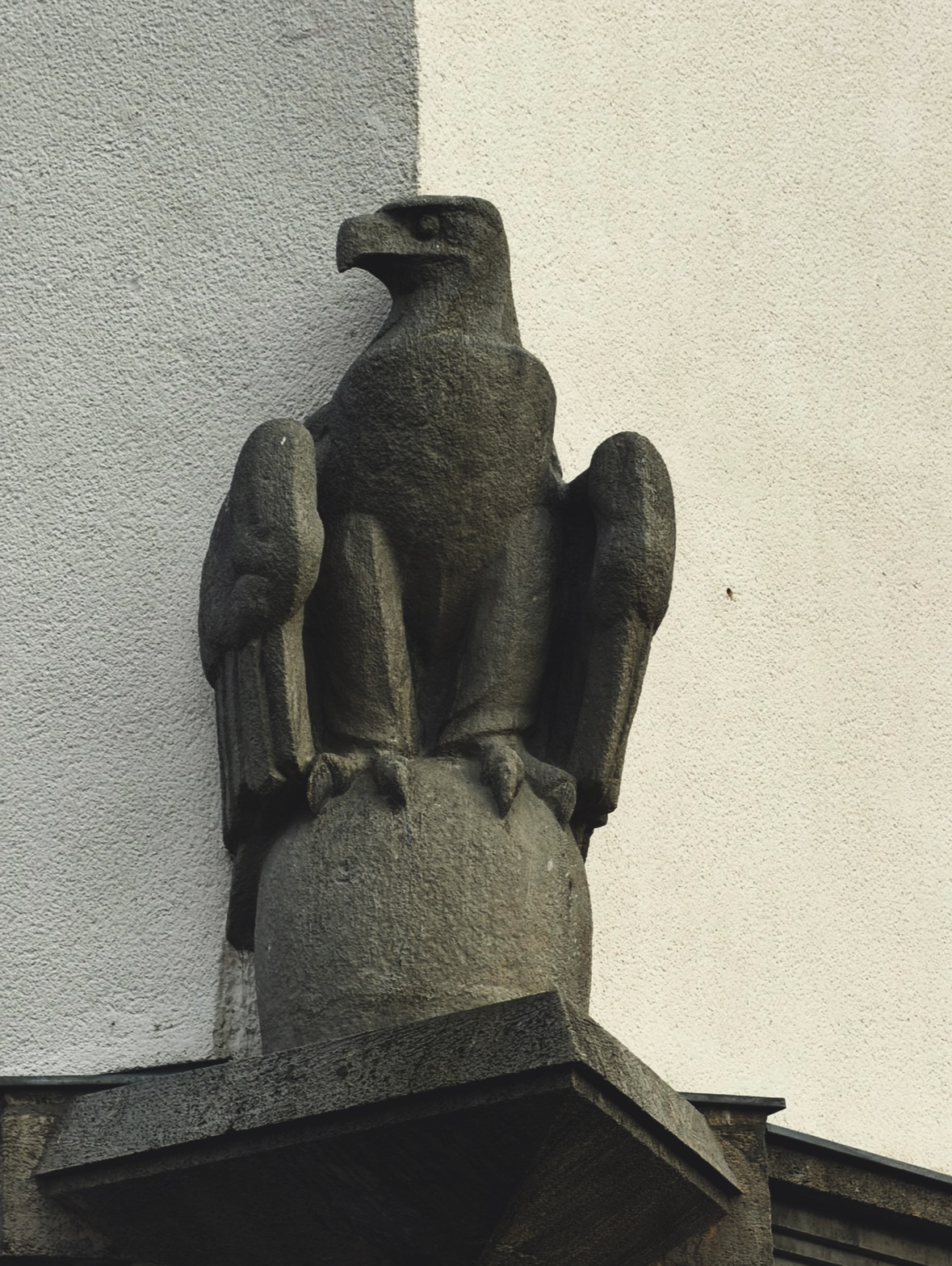 Dark stone eagle perched on an architectural corner